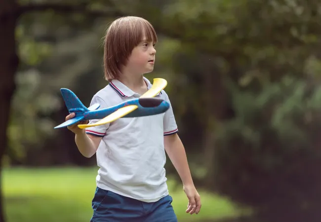 Child playing with airplane